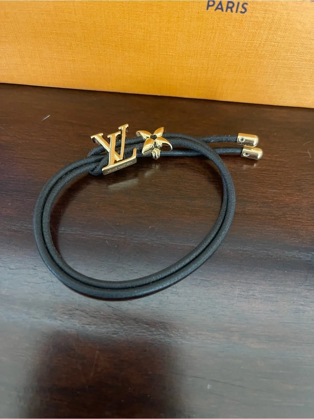 Louis Vuitton Blossom Black Cord Bracelet with Gold LV and Flower. Adjustable.